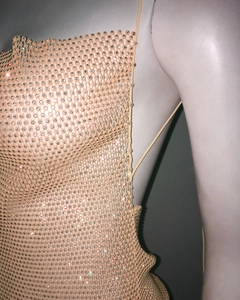 Detail of champagne rhinestone mesh dress featuring luxury crystal chains and spaghetti straps