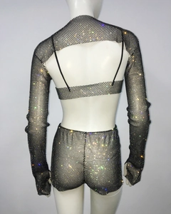 Macro detail of the black mesh three-piece set with shimmering rhinestones and backless shrug