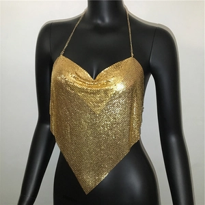 Close-up of gold metal mesh sequins and chain details on a sexy halter crop top