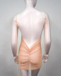 Detail of backless rhinestone mini dress showing deep V-back and sparkling mesh fabric