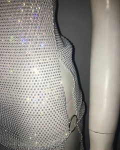 Detail of a luxury white bead and crystal dress featuring silver metal ring cutouts