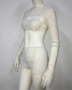 Detailed view of silver rhinestones on a three-piece mesh set with long sleeves and shorts