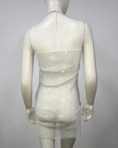 Close-up of white mesh bodycon dress with sparkling rhinestones and matching chain necklace