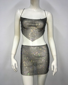 Detail of black rhinestone mesh two-piece set featuring a halter crop top and mini skirt