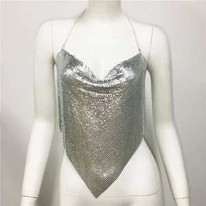 Detailed close-up of silver sequin halter top featuring a metallic mesh V-shaped hem