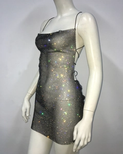Detail of black rhinestone fishnet mini dress with thin straps and open back design