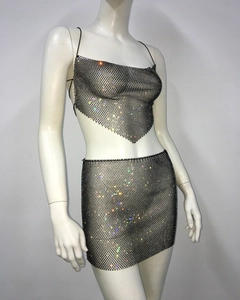 Close-up of shimmering rhinestone mesh crop top and mini skirt set on a mannequin