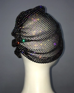 Detail of black mesh hat with colorful rhinestones and floral design on a model