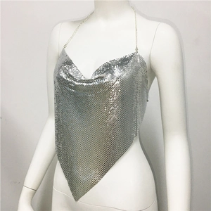 Detailed view of shiny silver metal sequins and chain straps on halter neck party top