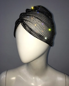 Close-up of black mesh turban headband with shimmering colorful and white rhinestones