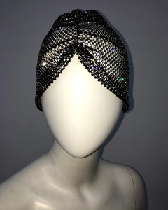 Detailed view of black rhinestones on a stretchy mesh turban headwrap accessory