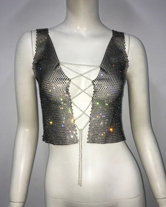 Detail of black mesh crop top with shimmering rhinestones and silver metal chain lacing