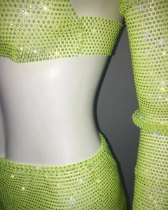 Detailed view of neon green rhinestone mesh party set with top, skirt, and sleeves