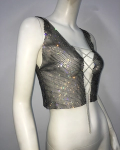 Macro detail of sexy rhinestone chain vest with shimmering metal mesh and V-neck tie