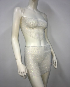 Detailed close-up of a sparkling rhinestone mesh crop top and mini skirt set on a mannequin