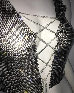 Close-up of sexy black fishnet top with shimmering rhinestones and metal chain straps