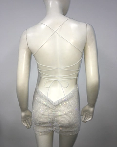 Detail of silver rhinestone mesh mini dress featuring cross back straps and open back