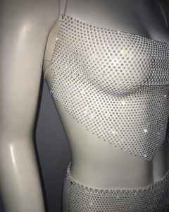 Close-up detail of silver rhinestone mesh fabric on sexy two-piece skirt set for parties