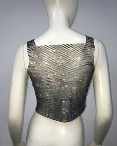 Back view of a black mesh crop top with colorful rhinestones on a white mannequin