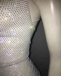 Detailed close-up of mesh dress featuring sparkling rhinestones on fishnet fabric