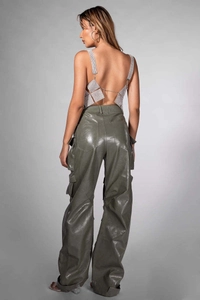 Detail of silver rhinestone halter top paired with olive green shiny faux leather cargo pants