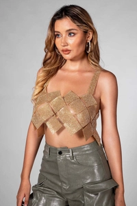 Detailed view of golden rhinestone patchwork camisole and shiny leather cargo pants