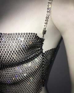 Close-up of black rhinestone mesh camisole featuring glittering crystals and chain straps