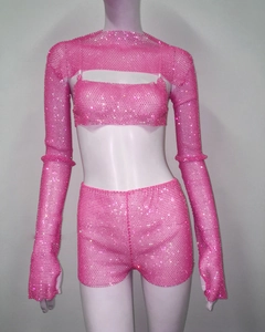 Detailed view of pink three-piece fishnet set with sparkling rhinestones on mannequin