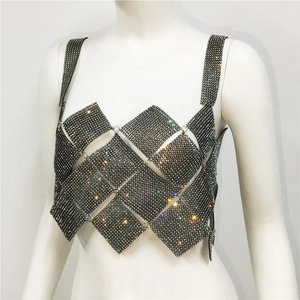 Macro shot of diamond-encrusted rhomboid mesh stitching on a sexy sparkling rhinestone top