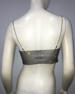 Detail shot of shimmering silver rhinestone fishnet top with delicate metal chain mesh