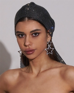 Close-up of black mesh rhinestones headwrap and sparkling star earrings for stage performances