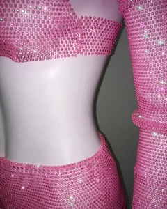 Detailed view of pink mesh fabric featuring shimmering silver rhinestones on the outfit
