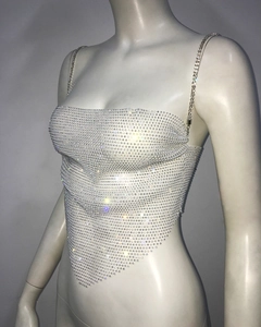 Detailed view of rhinestone mesh camisole featuring thin metal chains and triangular hem