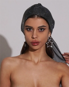 Close-up of luxury sparkling rhinestone mesh turban and large star-shaped earrings