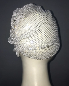 Close-up of white luxury beaded headpiece with sparkling rhinestones on a mannequin head