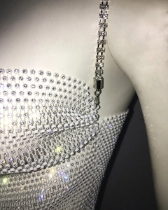 Detailed macro view of white bead mesh with rhinestones and double-row diamond straps