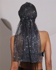 Detail view of shimmering rhinestones on black mesh fabric long tail headscarf turban