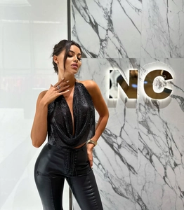 Detail of the black sequin metal mesh halter top with a deep V-neck drape and metal chain