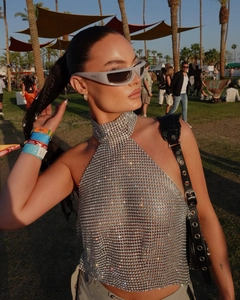 Detailed view of silver mesh halter top with shimmering sequins and metal ring texture