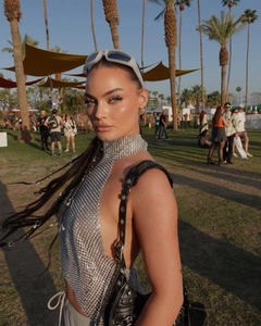 Silver metal sequin halter top with mesh design worn at a sunset music festival