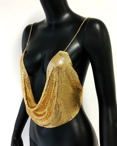 Detailed close-up of golden metallic sequin halter top with fine chain mesh texture