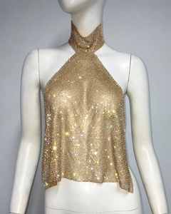 Detailed view of shimmering gold metallic mesh halter crop top with sparkling rhinestones