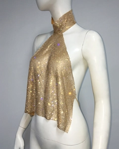 Detailed side view of golden halter neck sequin mesh top with sparkling rhinestones