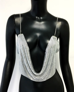 Detailed close-up of silver metal sequin camisole with deep V-neck and chain straps