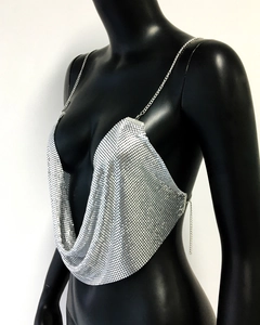 Close-up of silver metal mesh bralette with plunging neckline and chain straps