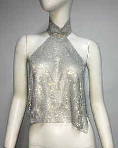 Detail of silver metallic mesh crop top with shimmering rhinestones and halter neck design