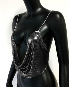 Detailed side view of a shiny silver sequin crop top with metallic chain straps