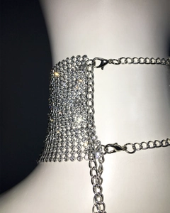 Detail of silver rhinestone choker with mesh structure and lobster clasp on white mannequin