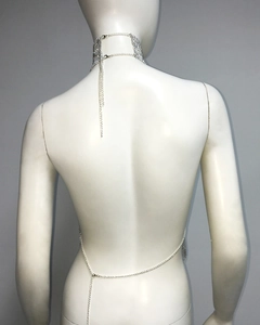 Detail view of a silver mesh metal body chain with choker and crisscross back design