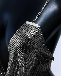 Close-up of silver metal mesh camisole featuring sequin texture and chain straps